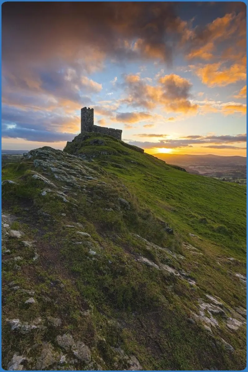 Stone tower on a hill at sunset