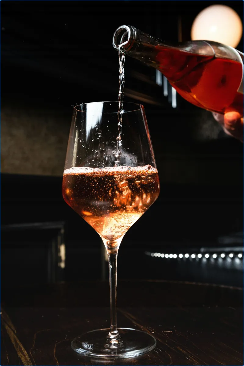 Rosé wine being poured into a glass.