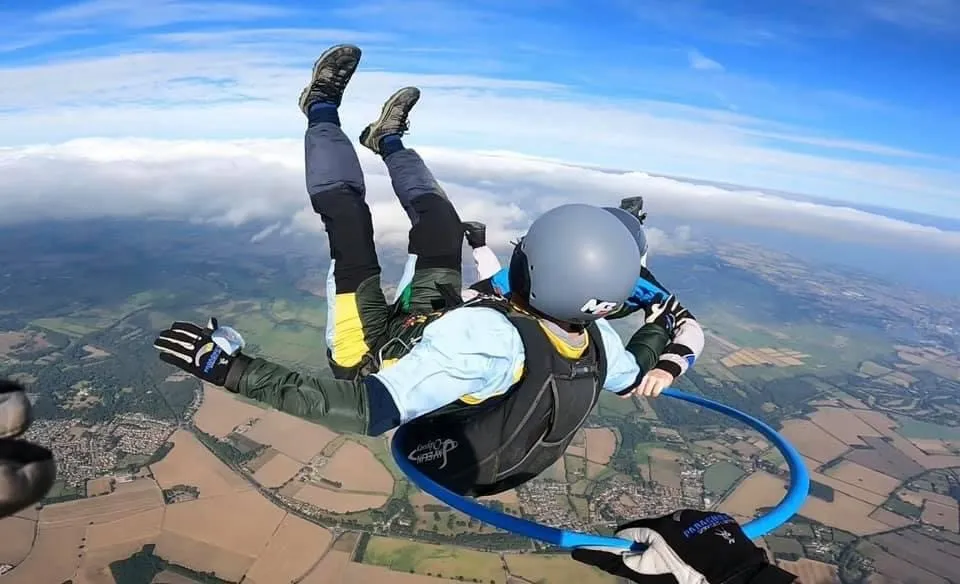 Solo skydiver enjoying freefall with stunning aerial views