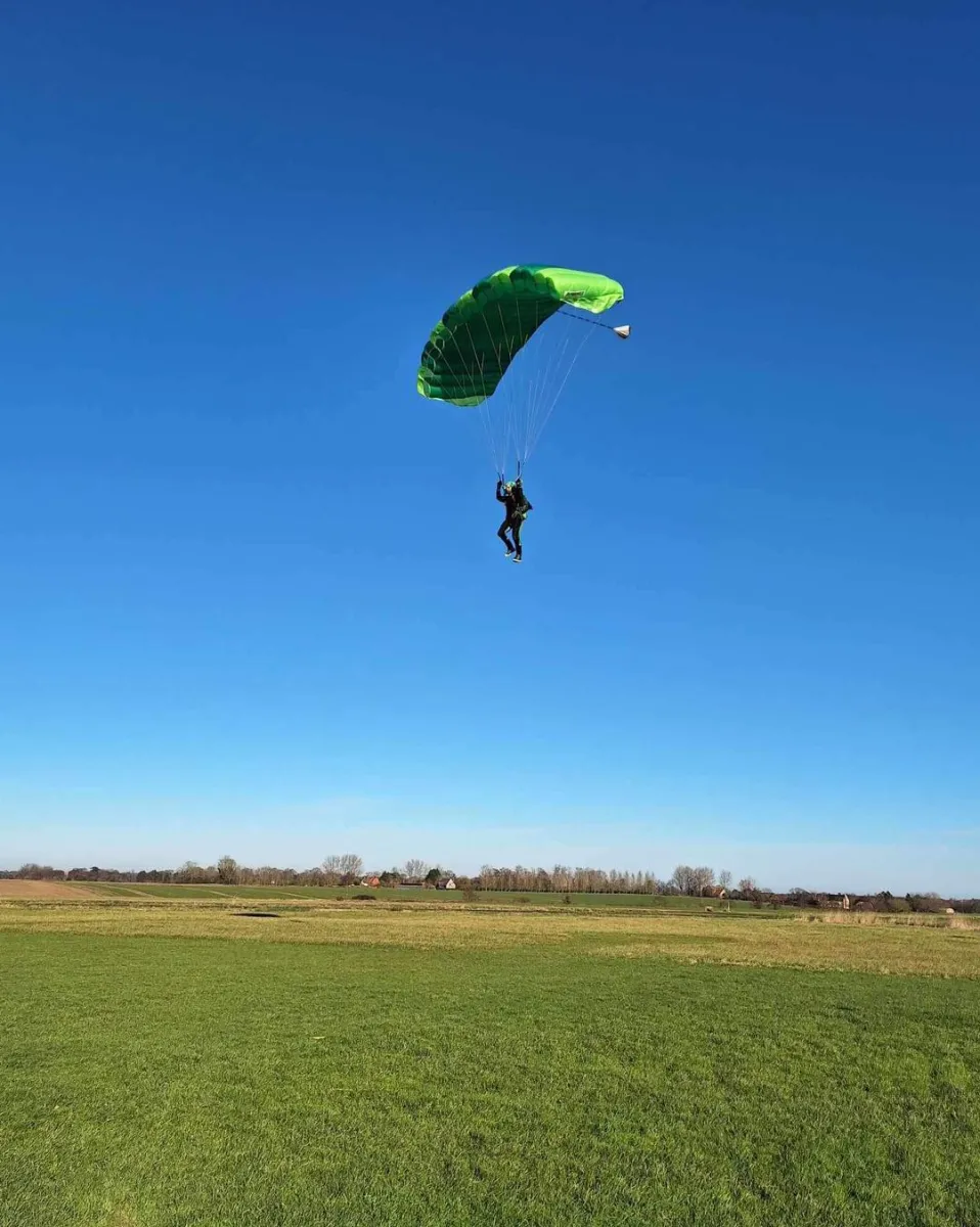 Group of skydivers in freefall during tandem jump