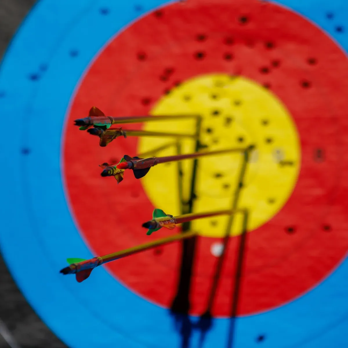 Arrows hitting a colorful archery target