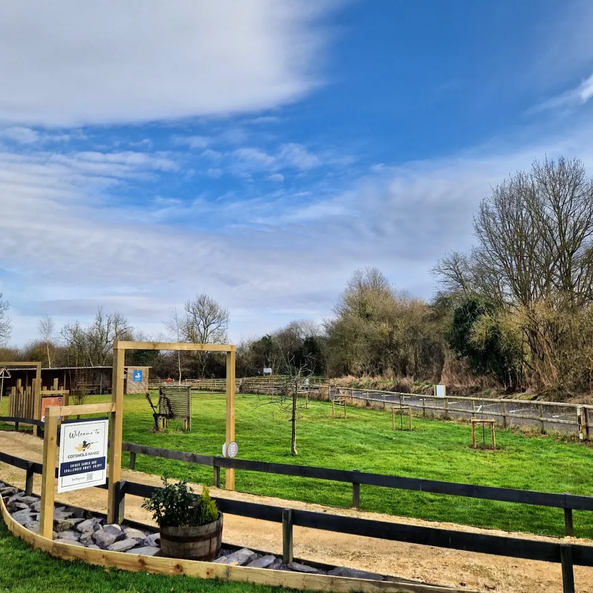 Outdoor archery range with wooden targets and trees.
