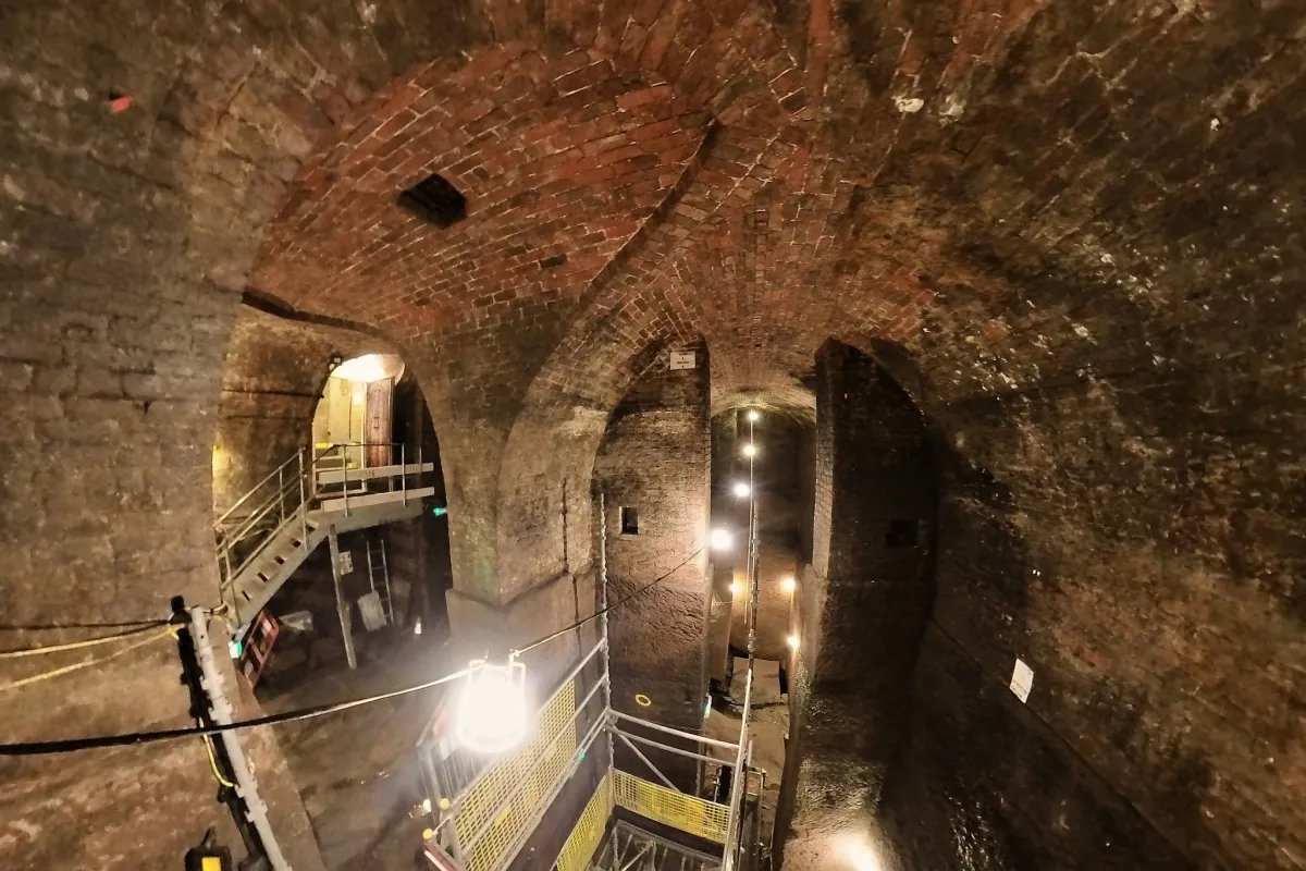 Interior of a historic brick tunnel with arches