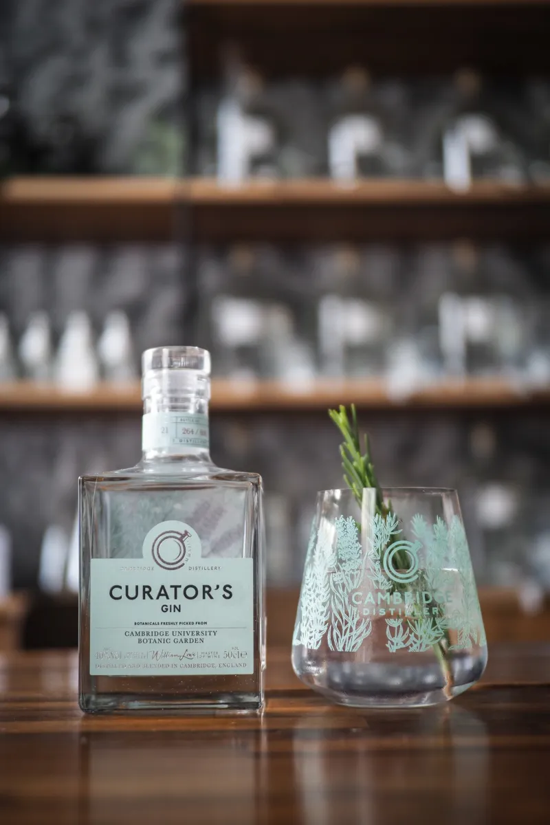 Bottle of Curator's Gin and a glass with garnish