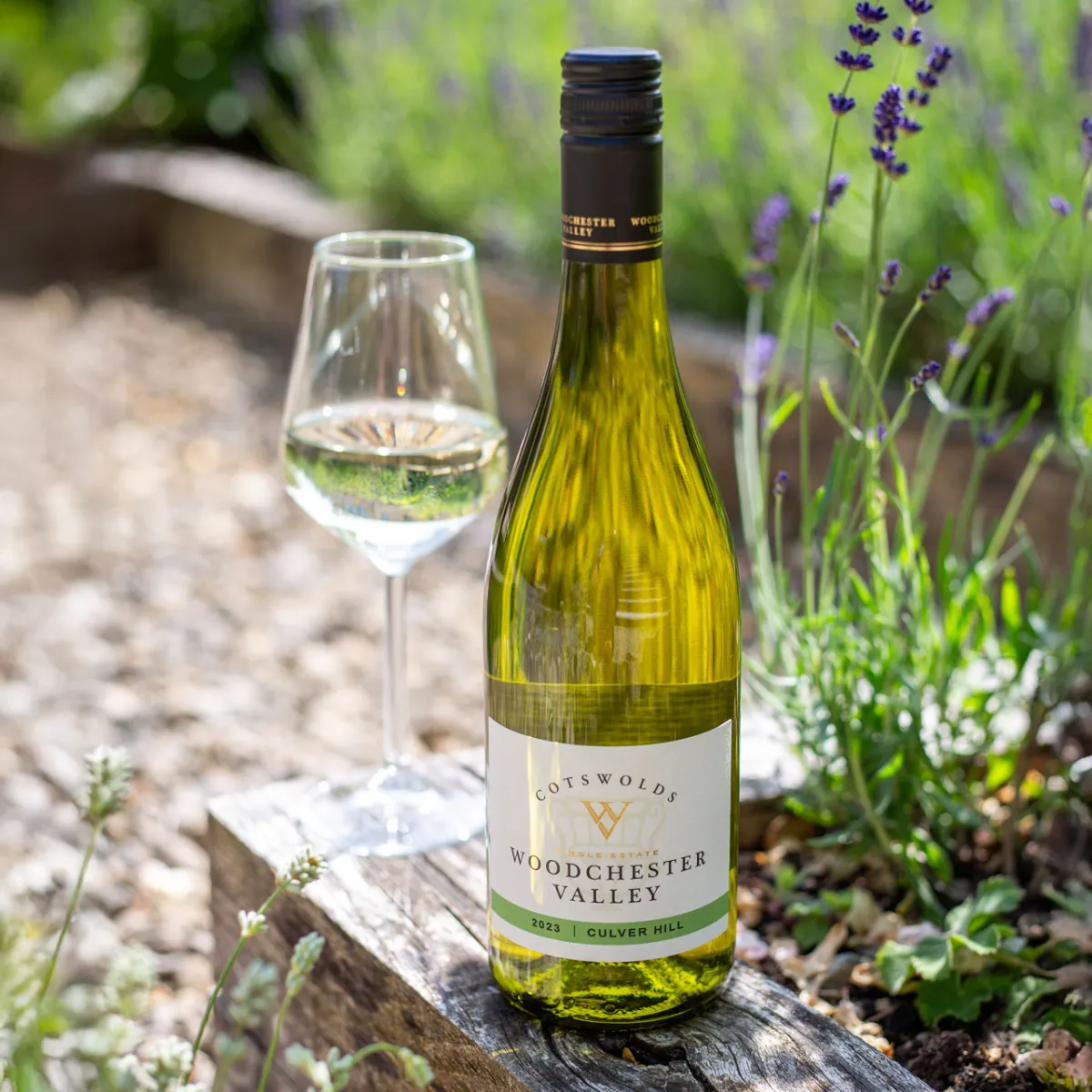 Bottle of Woodchester Valley wine with a glass outdoors.